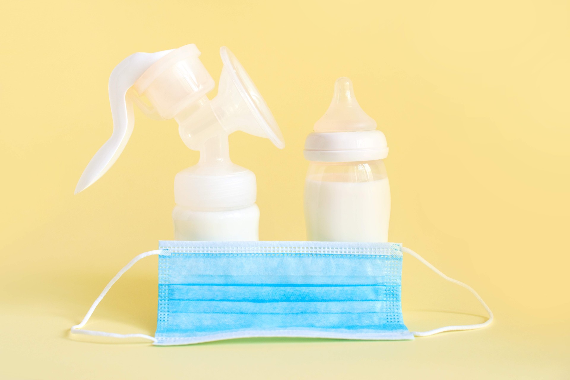 bottles of breast milk with a medical mask